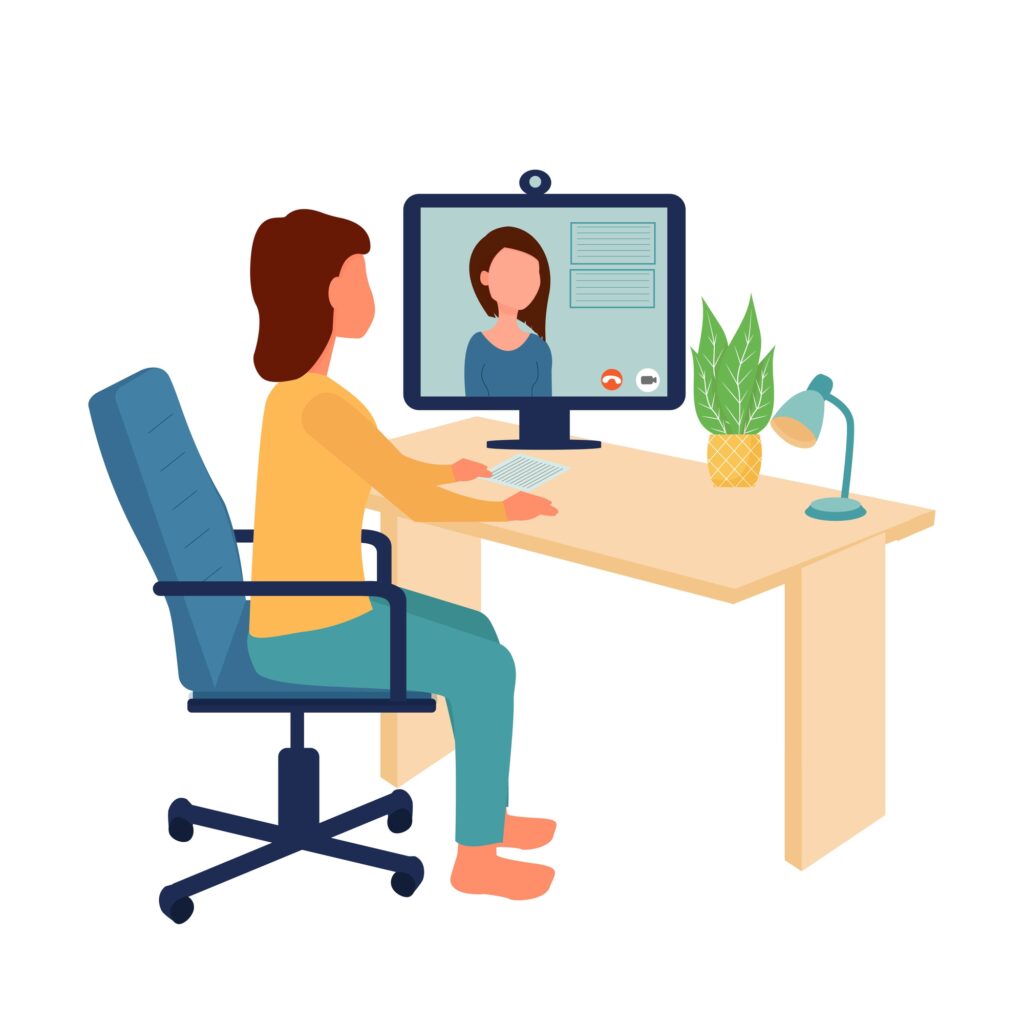 Woman sitting at desk happy with her personalized bookkeeping coaching.